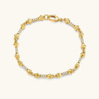 Gold-plated sterling silver bracelet with bone-shaped links, embedded CZ stones, and lobster clasp on light background.