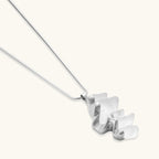 Modern sculptural jewelry set with flowing ribbon-like earrings and matching pendant in eco-zinc alloy finish