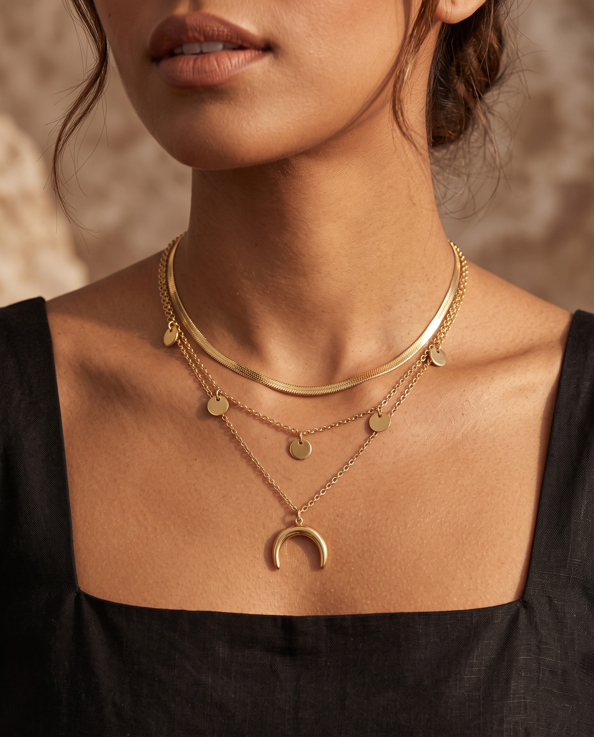 Woman wearing the Golden Crescent Layer Set, three gold chains with crescent moon pendant