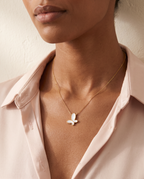 Woman wearing the Flutter Dream Necklace, mother of pearl butterfly pendant